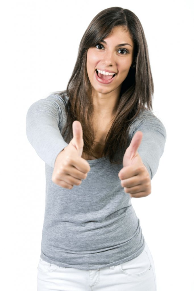 Woman smiling with her thumbs up.