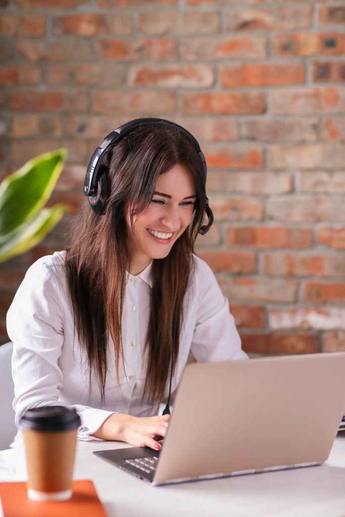 Female sales assistant, sitting at a desk and talking to a customer.