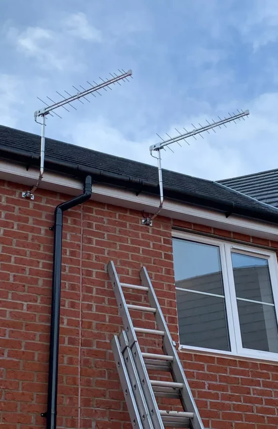 Two log periodic TV aerials installed on j masts.