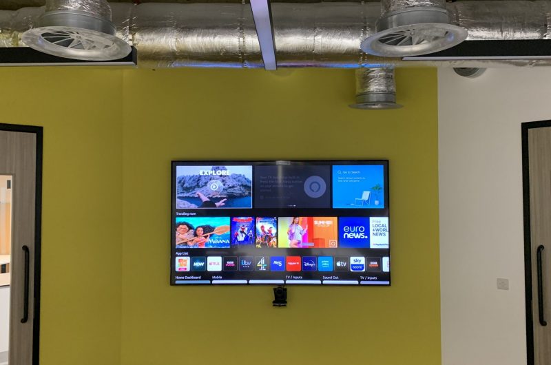 85 inch Samsung TV installed on a wall in a commercial building.